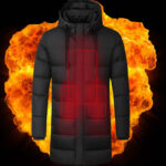 blouson chauffant noir avec batterie manche longue, en arrière plan du feu