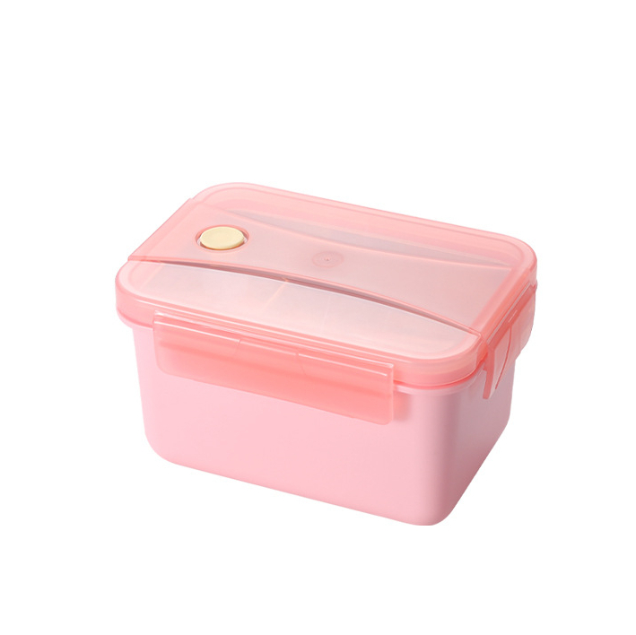 On voit un lunch box chauffant rose sur fond blanc.