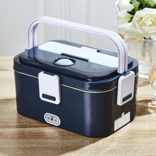 On voit un lunch box chauffant bleu marine et blanc sur une table en bois.